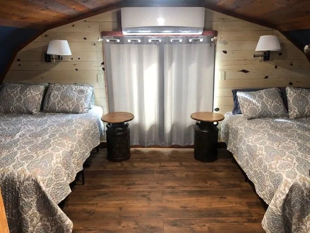 Barn loft bedroom with two queen beds